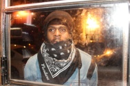 Photographer Mitchell Louis, 31, peeks in through the window of The Flat in Brooklyn, NYC, 02/07/2014 ©Sumi Naidoo, 2014